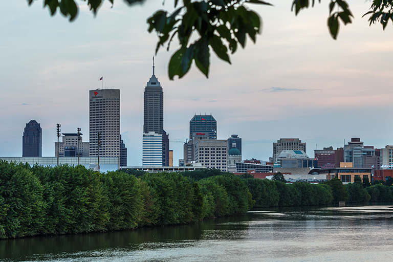 A view of the city skyline of Indianapolis from across a river.